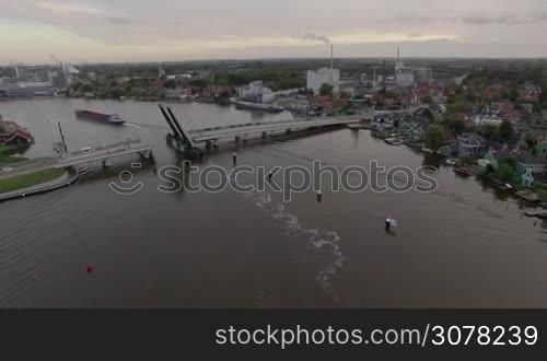 Aerial shot of drawbridge going down after ship sailing through it. Scene in village of Netherlands