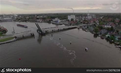 Aerial shot of drawbridge going down after ship sailing through it. Scene in village of Netherlands