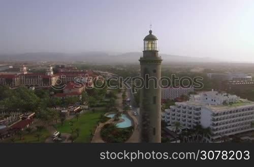 Aerial shot of resort town on the coast of Gran Canaria with Maspalomas Lighthouse in foreground