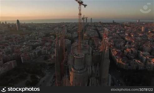 Aerial shot of Sagrada Familia and Barcelona cityscape. Famous unfinished Roman Catholic church and city landmark