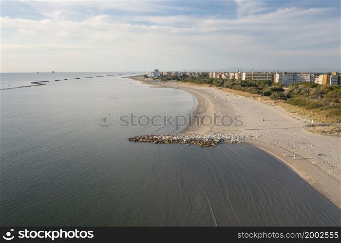 Aerial shot of sandy beach, typical adriatic shore.Summer vacation concept.Lido Adriano town,Adriatic coast, Emilia Romagna,Italy.