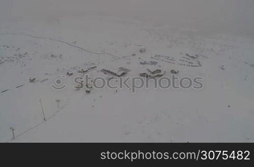 Aerial shot of ski resort in Khibiny mountains in heavy snowfall