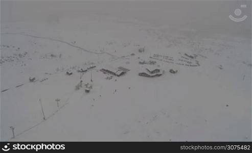Aerial shot of ski resort in Khibiny mountains in heavy snowfall