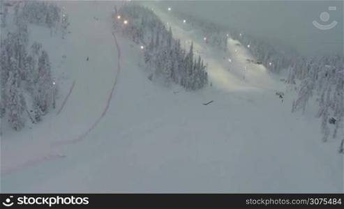 Aerial shot of slopes for downhill skiing, people are training on them