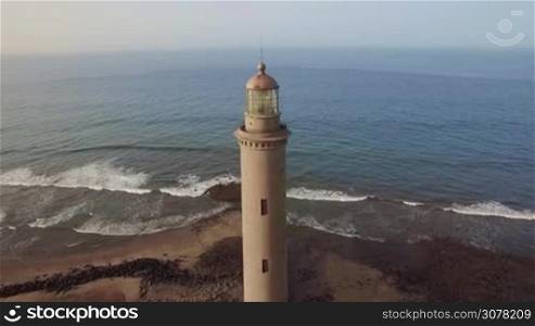 Aerial shot of the ocean and Maspalomas Lighthouse of 19th century on the coast of Gran Canaria