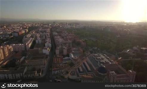 Aerial shot of Valencia with traffic on the roads. View to the third largest city in Spain at sunset