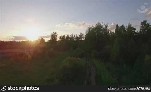 Aerial shot of village and railway at sunset. Dacha community in Russia