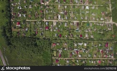 Aerial shot of village or dacha community with private houses. Countryside in Russia