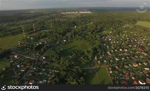 Aerial shot of villages or dacha communities among the green nature in Russia