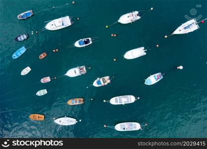 Aerial top down view of yachts and boats moored at a marina. High quality photo. . Aerial top down view of yachts and boats moored at a marina.