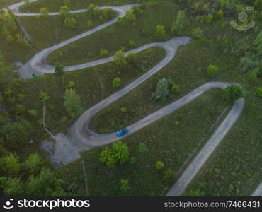 Aerial top vew of winding road in the city, drone shot. Aerial top vew of winding road in the city