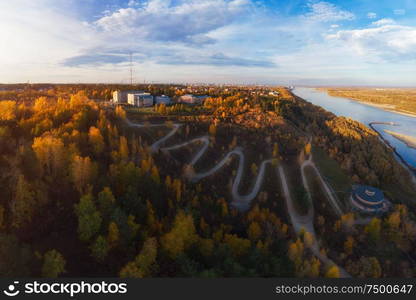 Aerial top vew of winding road in the city, drone shot. Barnaul, Siberia, Russia. Beauty autumn day. Aerial top vew of winding road in the city