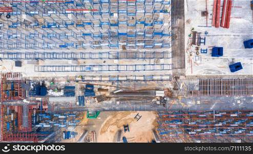 Aerial top view construction site with industrial consgruction machinery building for new factory buildings.