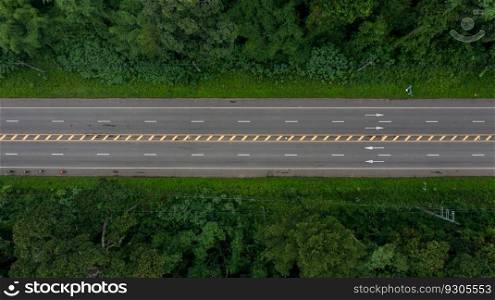 Aerial top view countryside highway asphalt road with forest, Aerial view road through the forest, Traffic highway between the natural parkland, Asphalt road through green tropical rainforest nature landscape.