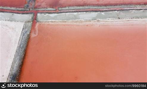 Aerial top view of beautiful salt lake with pink water. View of pink lake from flying drone. Drone copter photography from above. Landscape with drone