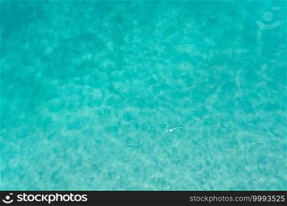Aerial top view of clear blue turquoise seawater, Andaman sea in summer season. Water in ocean material surface pattern texture wallpaper background.