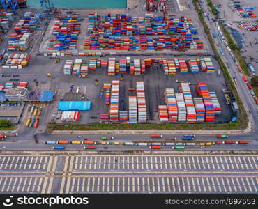 Aerial top view of container cargo ship in the export and import business and logistics international goods in urban city. Shipping to the harbor by crane in Laem Chabang, Chon Buri, Thailand