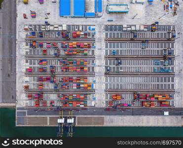 Aerial top view of container cargo ship in the export and import business and logistics international goods in urban city. Shipping to the harbor by crane in Laem Chabang, Chon Buri, Thailand