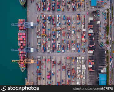 Aerial top view of container cargo ship in the export and import business and logistics international goods in urban city. Shipping to the harbor by crane in Laem Chabang, Chon Buri, Thailand