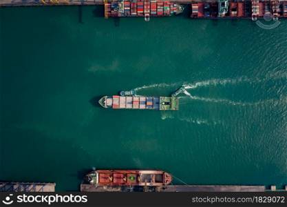 Aerial top view of containers ship floating in sea at shipping port for international import export cargo logistics transportation business services and industry