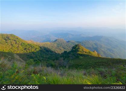 Aerial top view of forest trees and green mountain hills with fog, mist and clouds. Nature landscape background, Thailand.