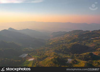 Aerial top view of forest trees and green mountain hills with fog, mist and clouds. Nature landscape background, Thailand.