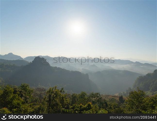 Aerial top view of forest trees and green mountain hills with sea fog, mist and clouds. Nature landscape background, Thailand.