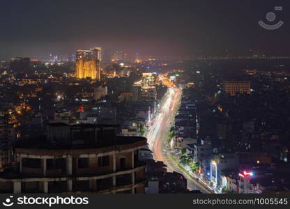 Aerial top view of Hanoi Downtown, Vietnam. Financial district and business centers in technology smart city in Asia. Top view of skyscraper and high-rise modern buildings at night.