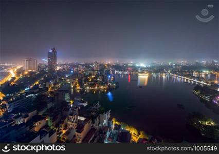 Aerial top view of Hanoi Downtown, Vietnam. Financial district and business centers in technology smart city in Asia. Top view of skyscraper and high-rise modern buildings at night.