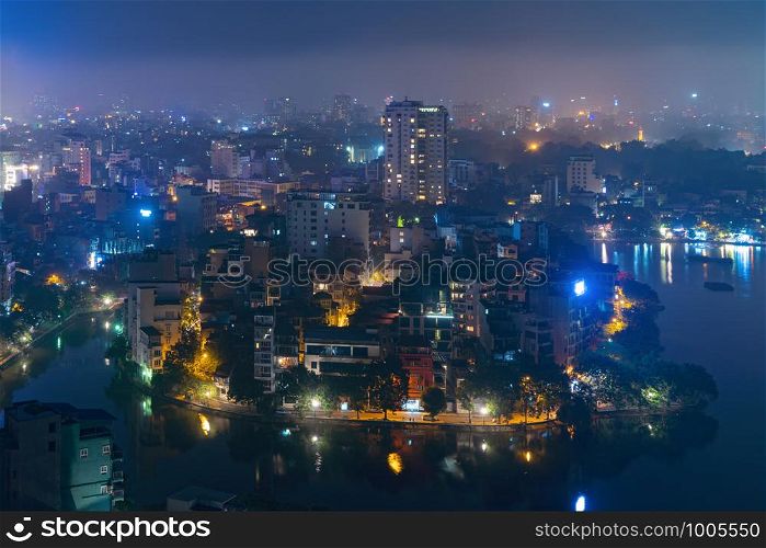 Aerial top view of Hanoi Downtown, Vietnam. Financial district and business centers in technology smart city in Asia. Top view of skyscraper and high-rise modern buildings at night.