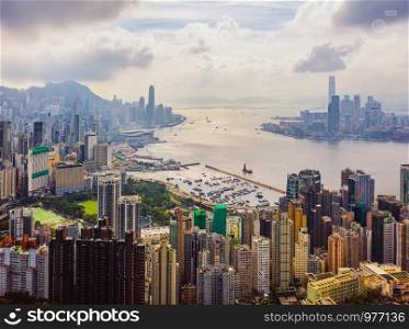 Aerial top view of Hong Kong Downtown, republic of china. Financial district and business centers in smart urban city in Asia. Skyscrapers and high-rise modern buildings at noon.