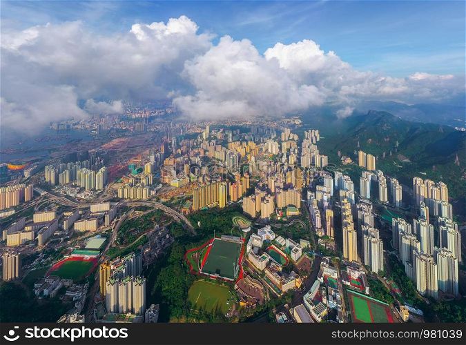 Aerial top view of Hong Kong Downtown, republic of china. Financial district and business centers in smart urban city in Asia. Skyscrapers and high-rise modern buildings with clouds at sunset sky.