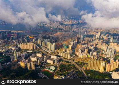 Aerial top view of Hong Kong Downtown, republic of china. Financial district and business centers in smart urban city in Asia. Skyscrapers and high-rise modern buildings with clouds at sunset sky.