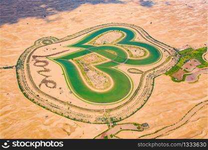 Aerial top view of love lake and sand desert, Heart shaped lakes in Al Qudra in Dubai, United Arab Emirates or UAE. A new tourist destination for valentine day. Natural landscape background