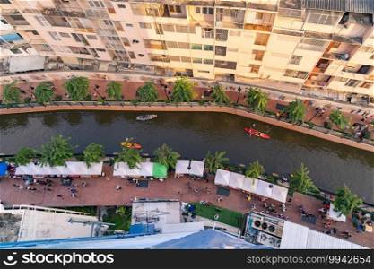 Aerial top view of tourists, paddling a boat, canoe or kayak in Bangkok Ong. Ang Canal in Thailand. People lifestyle adventure activity recreation. Walking street.