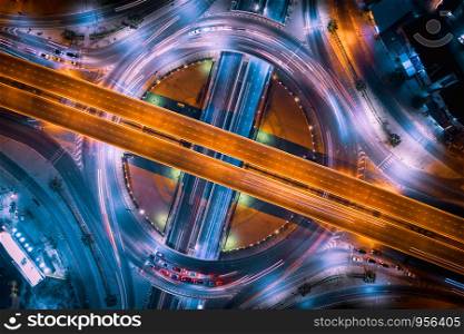 aerial top view ring road interchange and motorway expressway bypass for cars transportation connecting the city at night in Thailand from drone camera