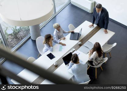 Aerial view at group of business people working together and preparing new project on a meeting in the office