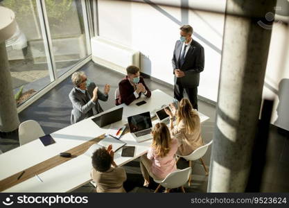 Aerial view at multiethnic group of business people working together and preparing new project on a meeting in the office