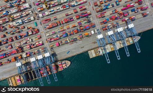 Aerial view cargo ship terminal, Unloading crane of cargo ship terminal, Aerial view industrial port with containers and container ship.