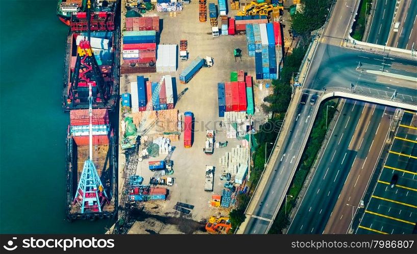 Aerial view cargo ships loaded by crane with cargo containers at a busy port terminal. Hong Kong
