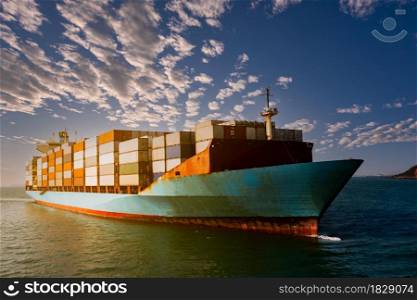 Aerial view container cargo ship carrying commercial container in import export business commerce logistic and transportation of international by container ship at morning over the sunlight blue sky background