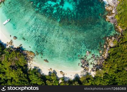 Aerial view drone shot ocean waves, Beautiful tropical beach and rocky coastline and beautiful forest. Nga Khin Nyo Gyee Island Myanmar. Tropical seas and islands in southern Myanmar