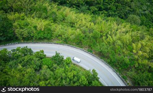 Aerial view forest nature with car on the road on the mountain green tree background, top view road curve from above countryside Asian