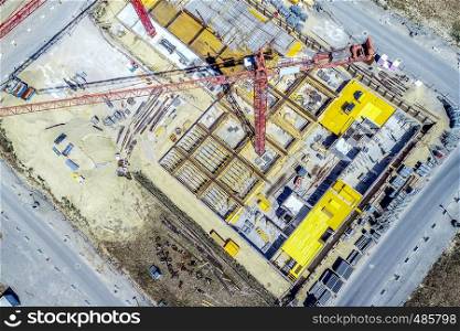 Aerial view from a greater height above the cranes of a construction site with the carcasses for new apartments in a growing German city, made with drone