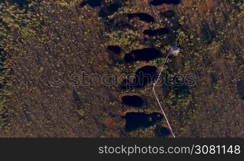 Aerial view from above on scenic swamps and lakes at sunset in the spring with long shadows from the sun