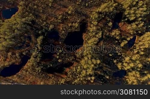 Aerial view from above on scenic swamps and lakes at sunset in the spring with long shadows from the sun