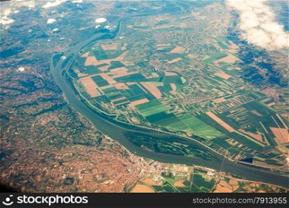 Aerial view from airplane on ground with fields, forest and rivers