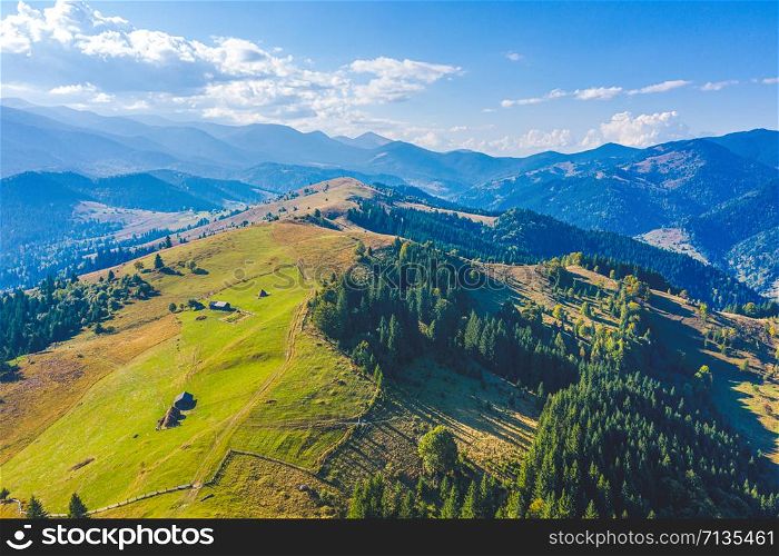 Aerial view from drone. Aerial view amazing over of the Carpathian Mountains or Carpathians with Beautiful summer landscape , sunny day, blue sky with white clouds
