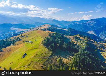 Aerial view from drone. Aerial view amazing over of the Carpathian Mountains or Carpathians with Beautiful summer landscape , sunny day, blue sky with white clouds