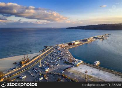 Aerial view from drone of seaport and breakwater at the stunning sunset. Black sea, Varna, Bulgaria